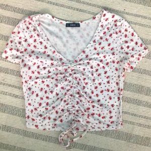 Pink floral top with a bunchy middle and tie